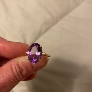 Costume amethyst ring with gold tone band and 2 small cz on side. Size 6.5